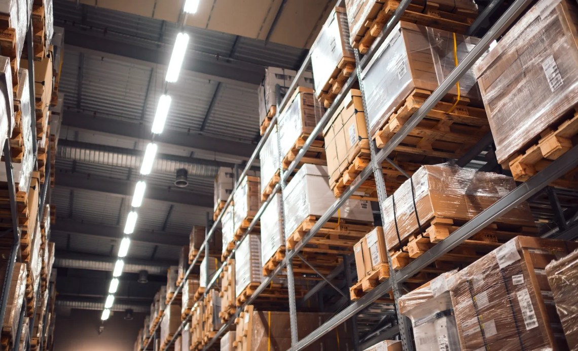 Warehouse racks full of inventory up to the ceiling.