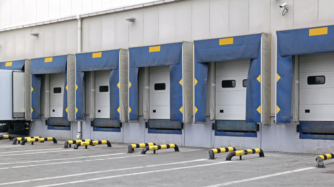 A row of warehouse loading docks prepared to receive inbound inventory