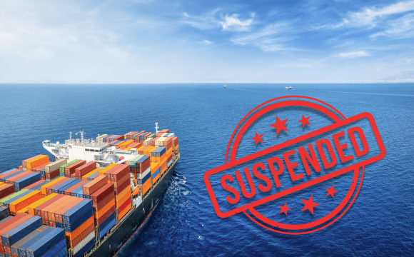 Freight ship in the ocean with a sticker with the word "suspended" on it, denoting the Section 321 suspension.