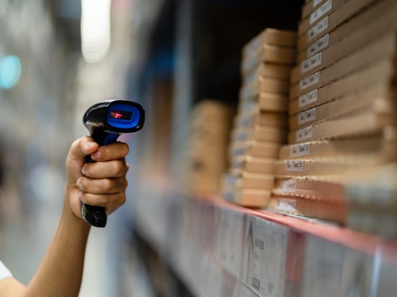 Warehouse worker using a scanner to scan the barcode inventory within the warehouse
