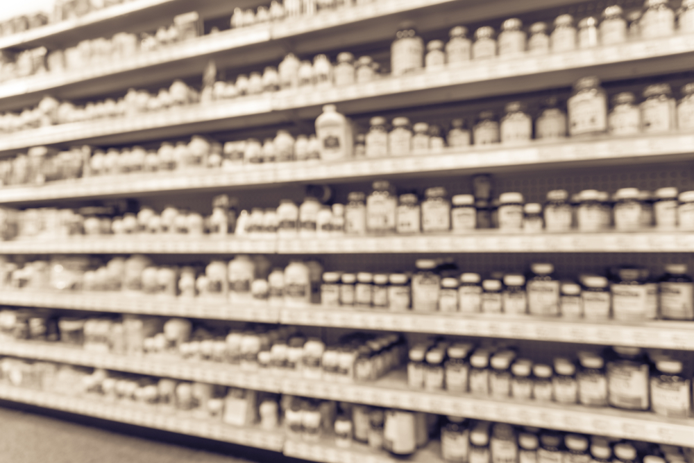 Blurred image vitamin store shelves, huge variation of vitamins, supplements, natural remedies, functional food, lifestyle support, herbal. Medical supplies product abstract background. Vintage tone._id528975964
