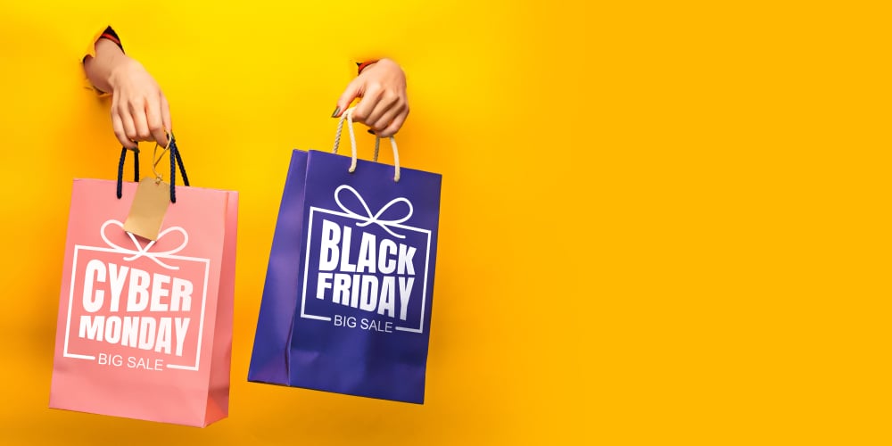 Hands holding gift boxes with black friday lettering on yellow background. Concept of sales, black friday, cyber monday, finance, business, money. Online shops and payments bill. Copyspace for ad_id1545607151