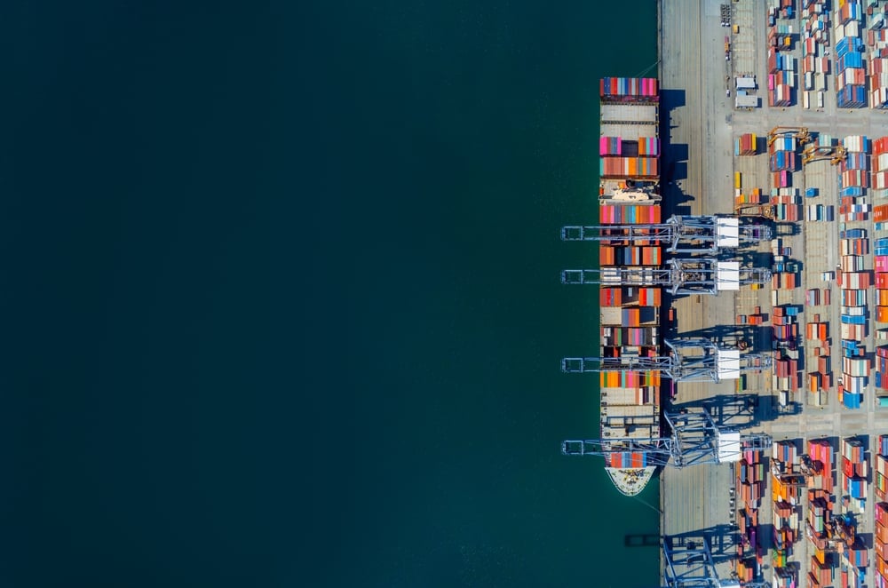 Ariel view transportation logistics and container dock cargo yard with cargo shipment working crane bridge in shipyard with transport logistic import export with twilight sky background._id2305477523