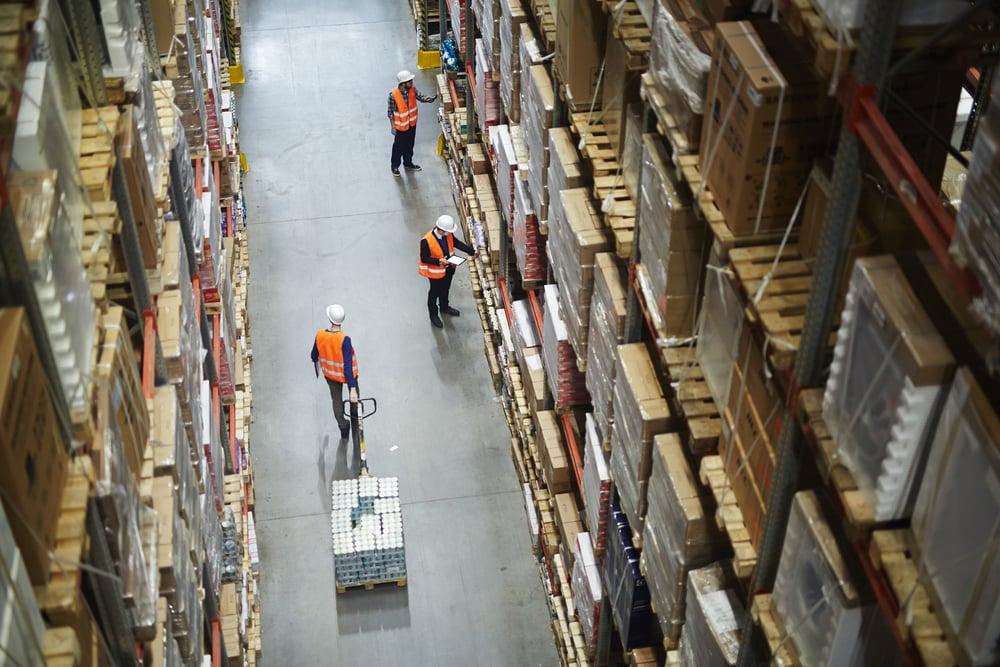 Employees in a warehouse moving inventory