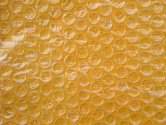 Yellow packaging with air bubbles background_id246801943