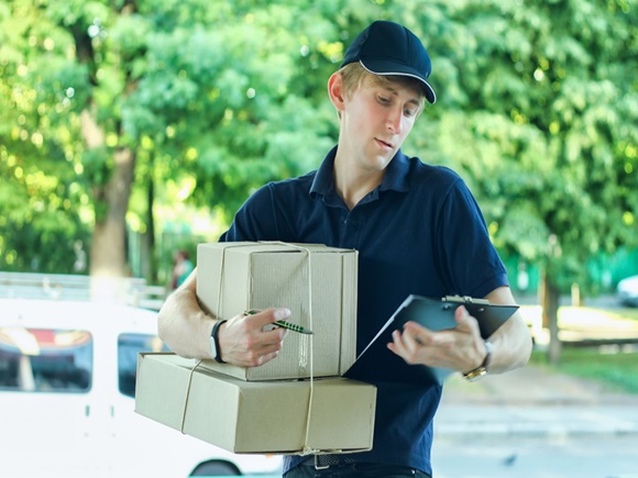 Delivery Man Delivering Package To Homeowner. Anonymous box concept_id1613296444