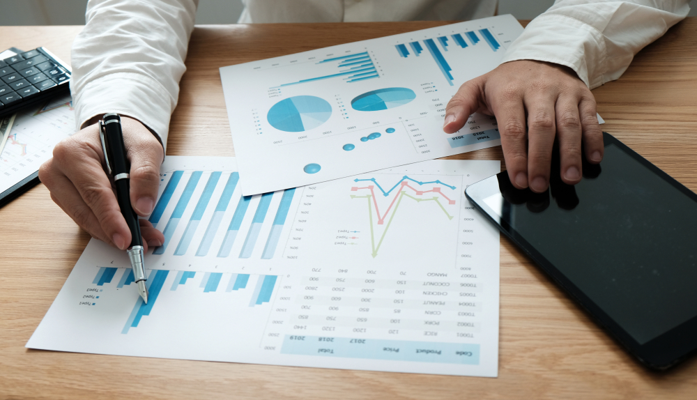 Person calculating finances for their ecommerce business and preparing their forecasts after using Period Monthly Statements for tariff deferral