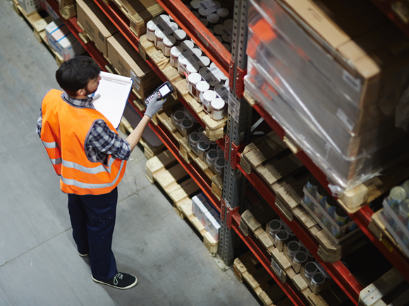 Logistics dispatcher scanning barcodes on packs with goods_id647680000