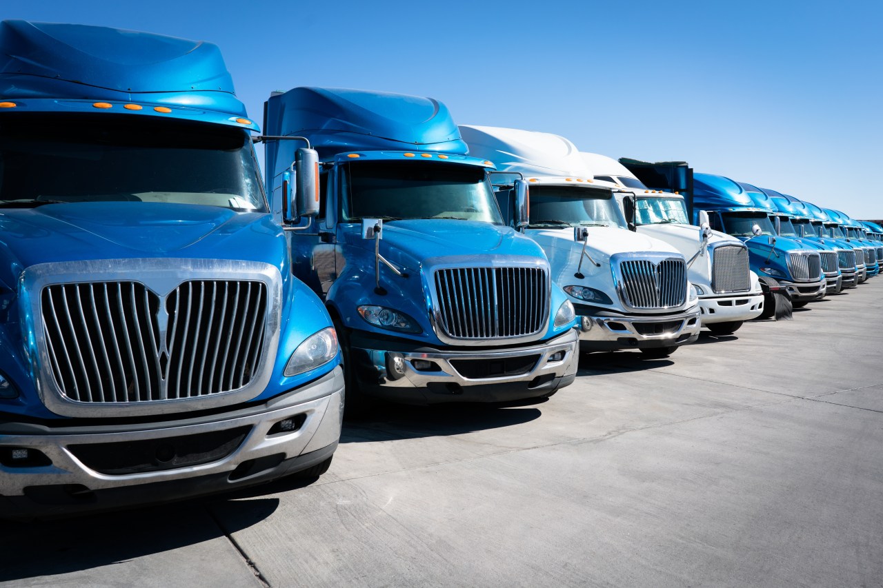 Line of several blue shipping cargo trucks
