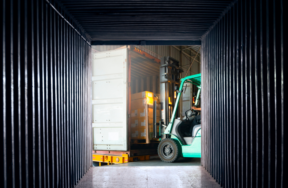 Freight transportation. Logistic concept Internal view an empty container shipping, forklift loading shipment pallet into container cargo._id1314988193