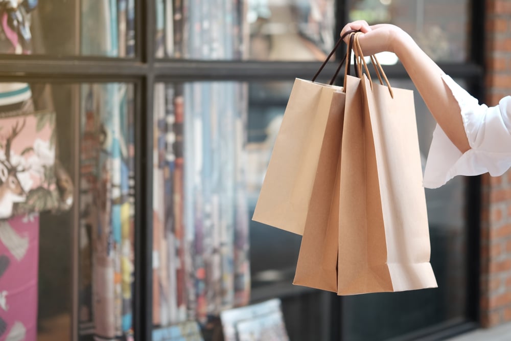Young woman holding sale shopping bags. consumerism lifestyle concept in the shopping mall_id1362638888