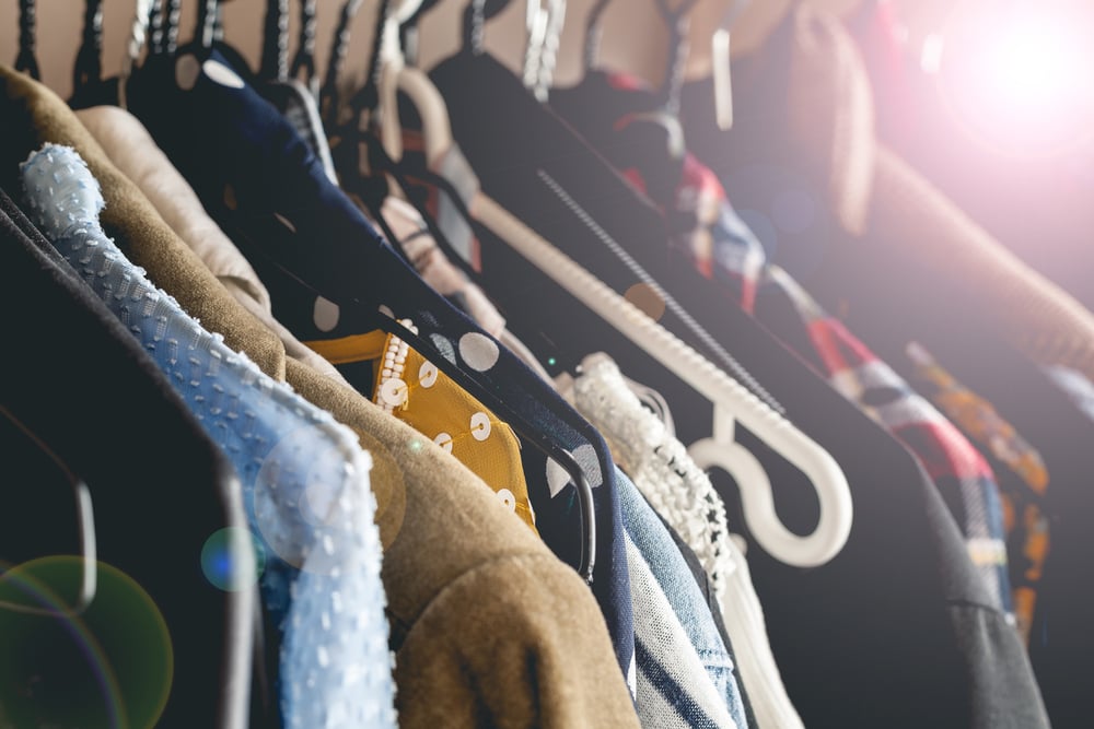 Womens vintage clothes hanging on a wooden rack_id640365526