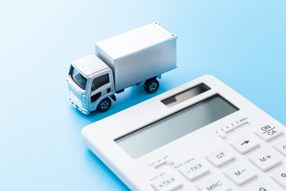 Small model carrier truck beside a calculator