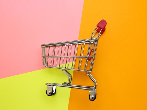Self-service supermarket full shopping trolley cart on colorful background _id1178417458