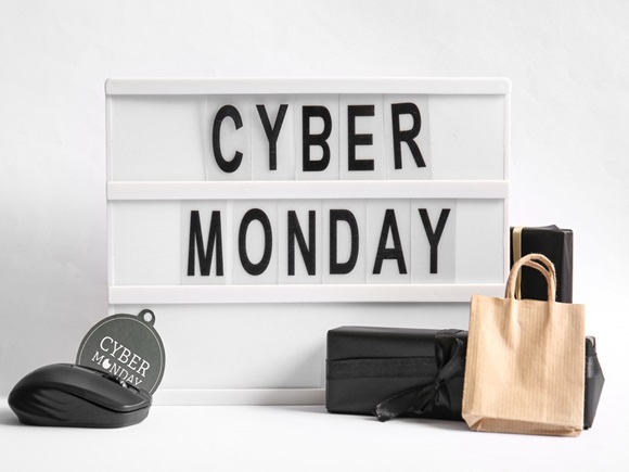 Board with text CYBER MONDAY, gift boxes and computer mouse on light background _id2382753831