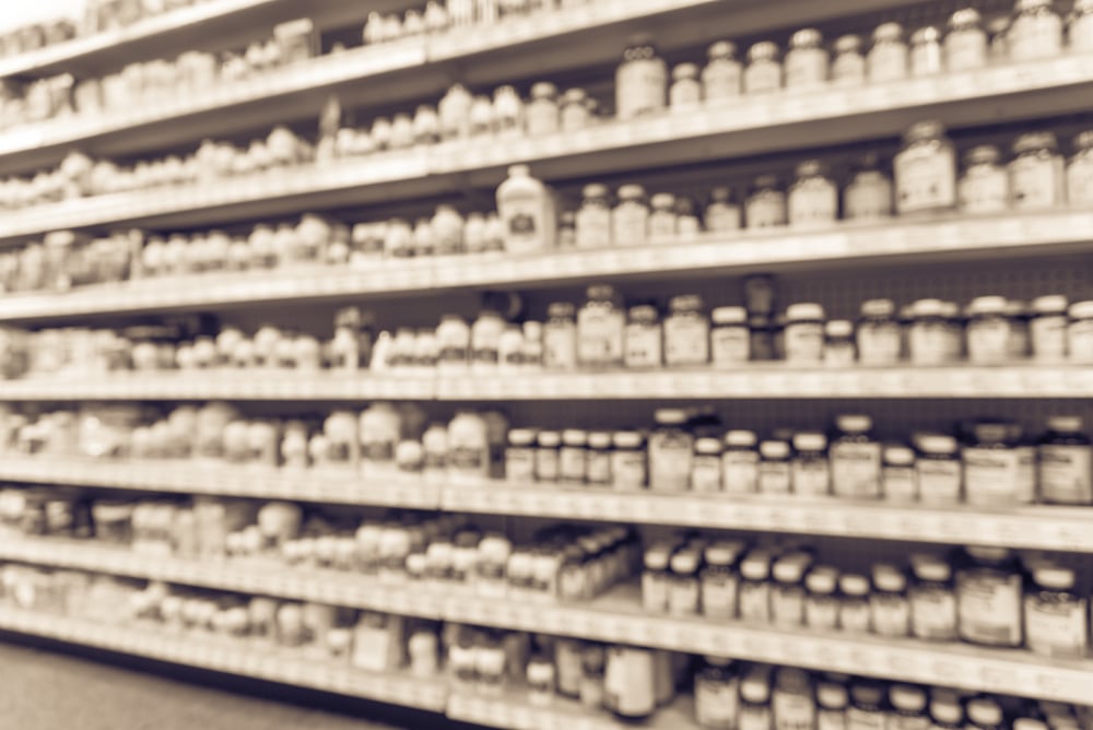 Blurred image vitamin store shelves, huge variation of vitamins, supplements, natural remedies, functional food, lifestyle support, herbal. Medical supplies product abstract background. Vintage tone._id528975964