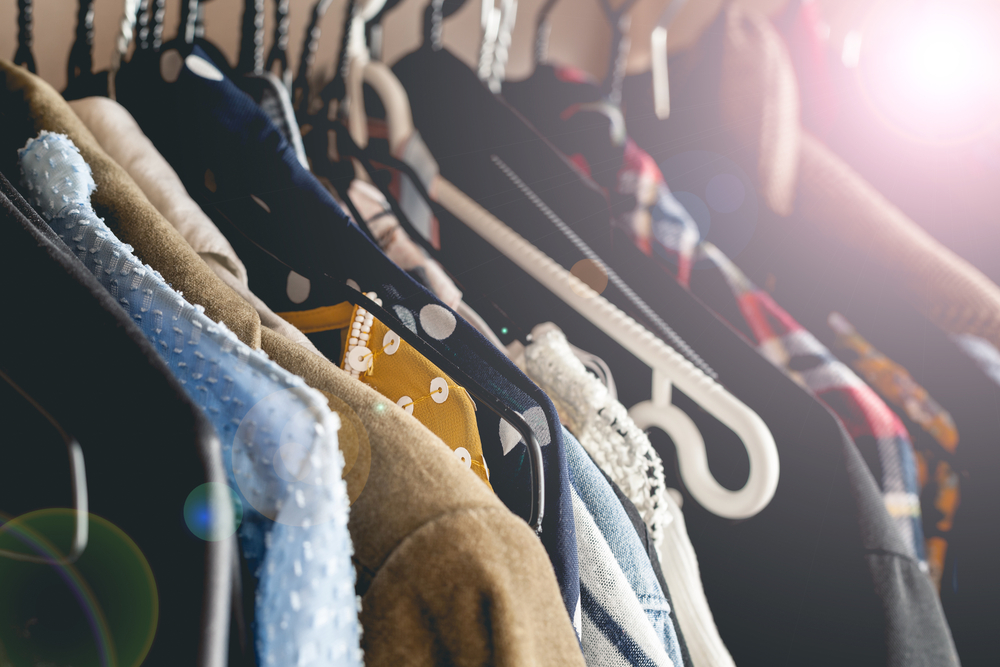 Womens vintage clothes hanging on a wooden rack_id640365526