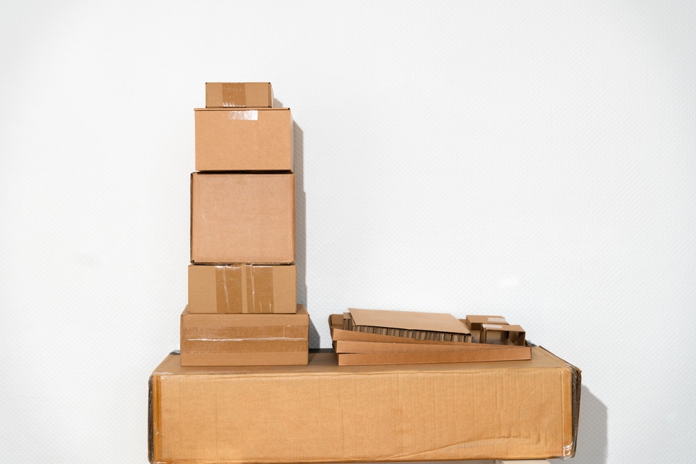 Creative minimalist image of stacked cardboard boxes on a plain background, representing concepts of moving, storage, shipping, and organization. Ideal for themes of simplicity and efficiency._id2568510015