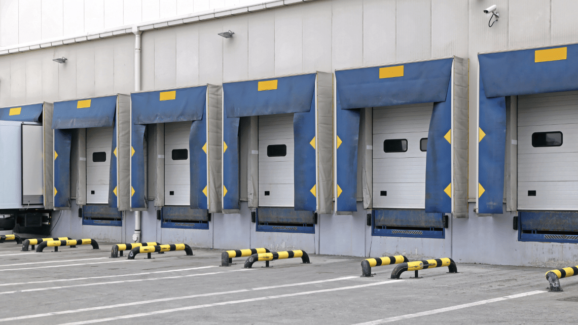 A row of warehouse loading docks prepared to receive inbound inventory