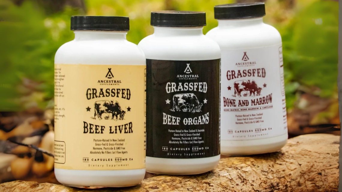 Image of 3 supplement bottles from Ancestral Supplements on a log in the woods