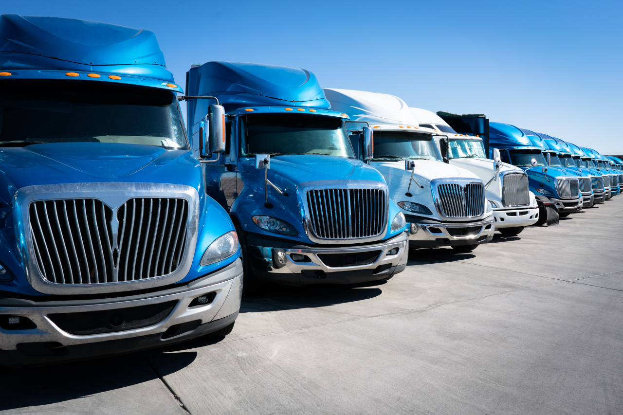 Line of several blue shipping cargo trucks