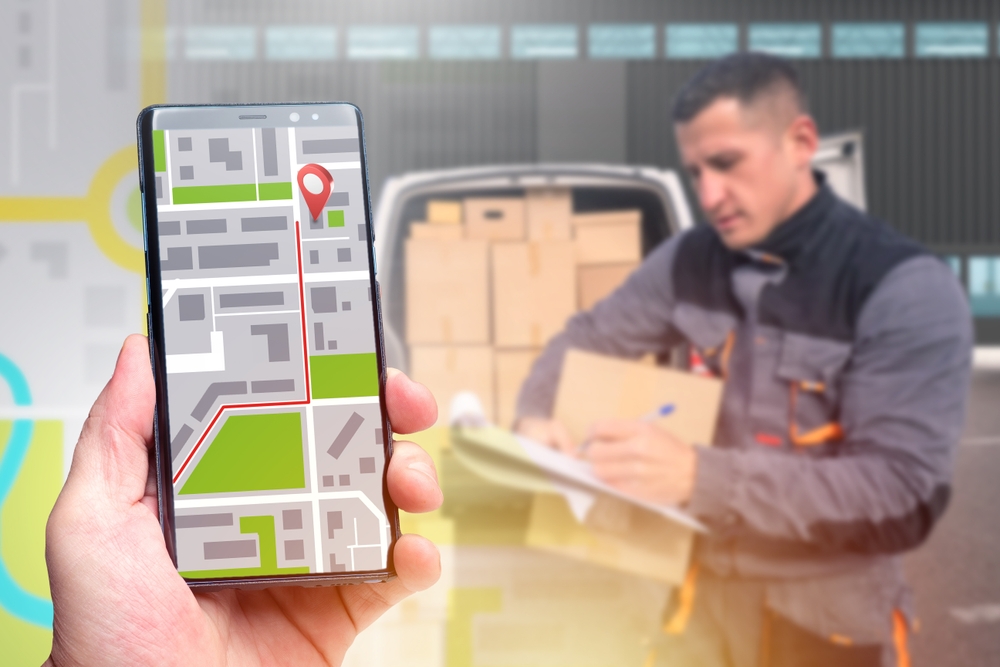 Person tracking their order while a mail carrier checks their paper in the background.